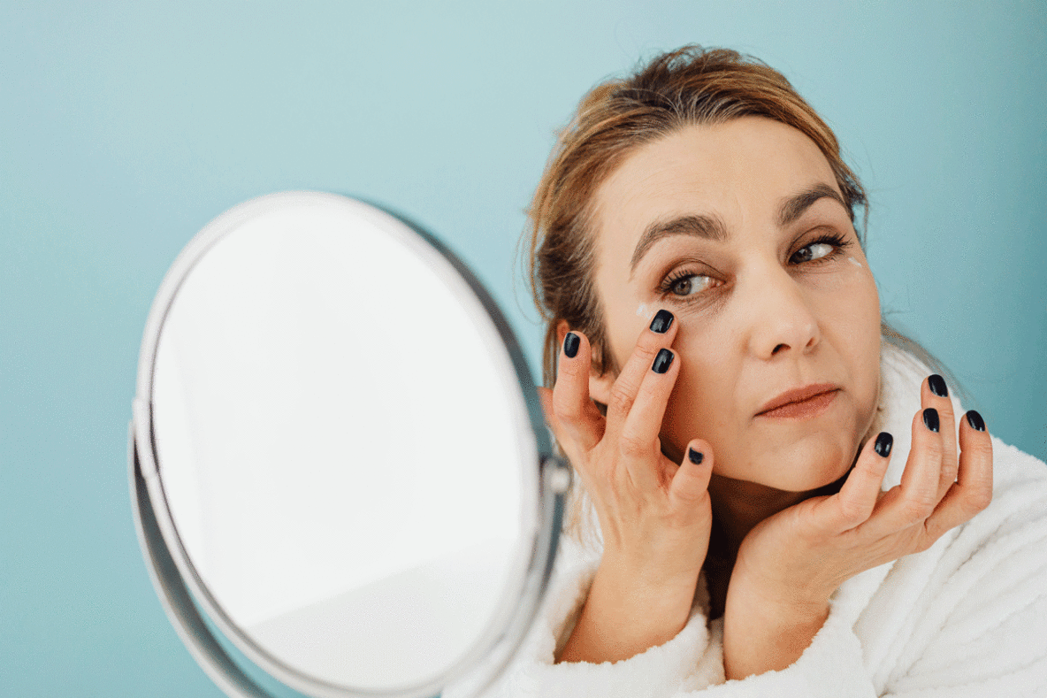Woman using eye cream for dark circles