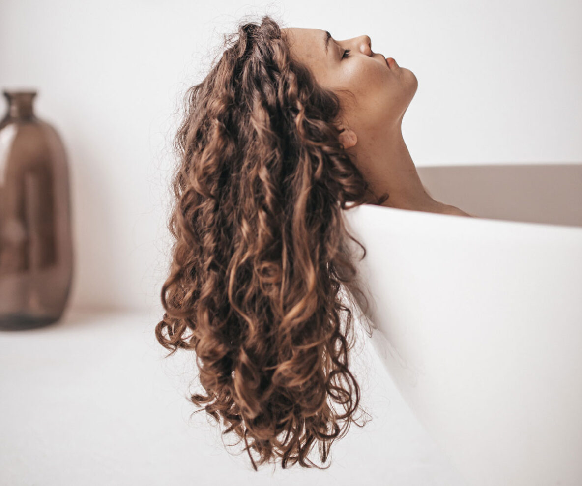 woman in bathtub with healthy hair