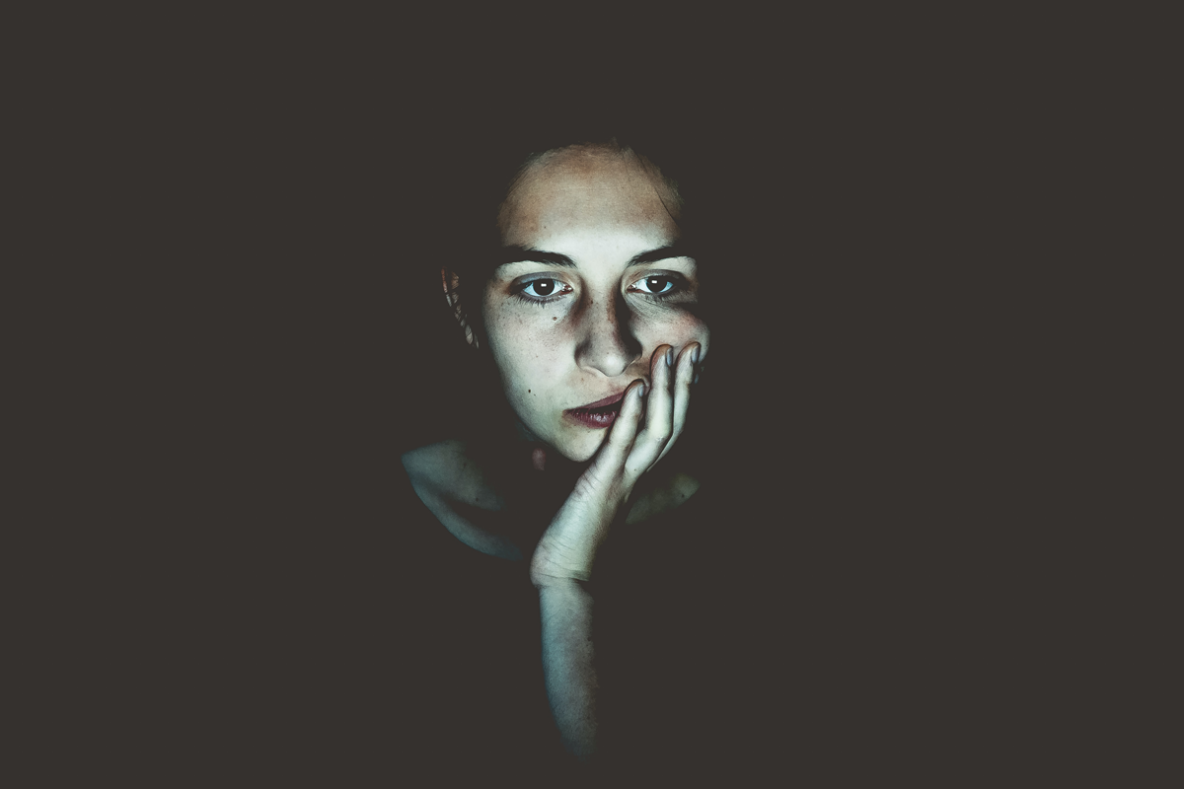 Woman staring at screen in the dark
