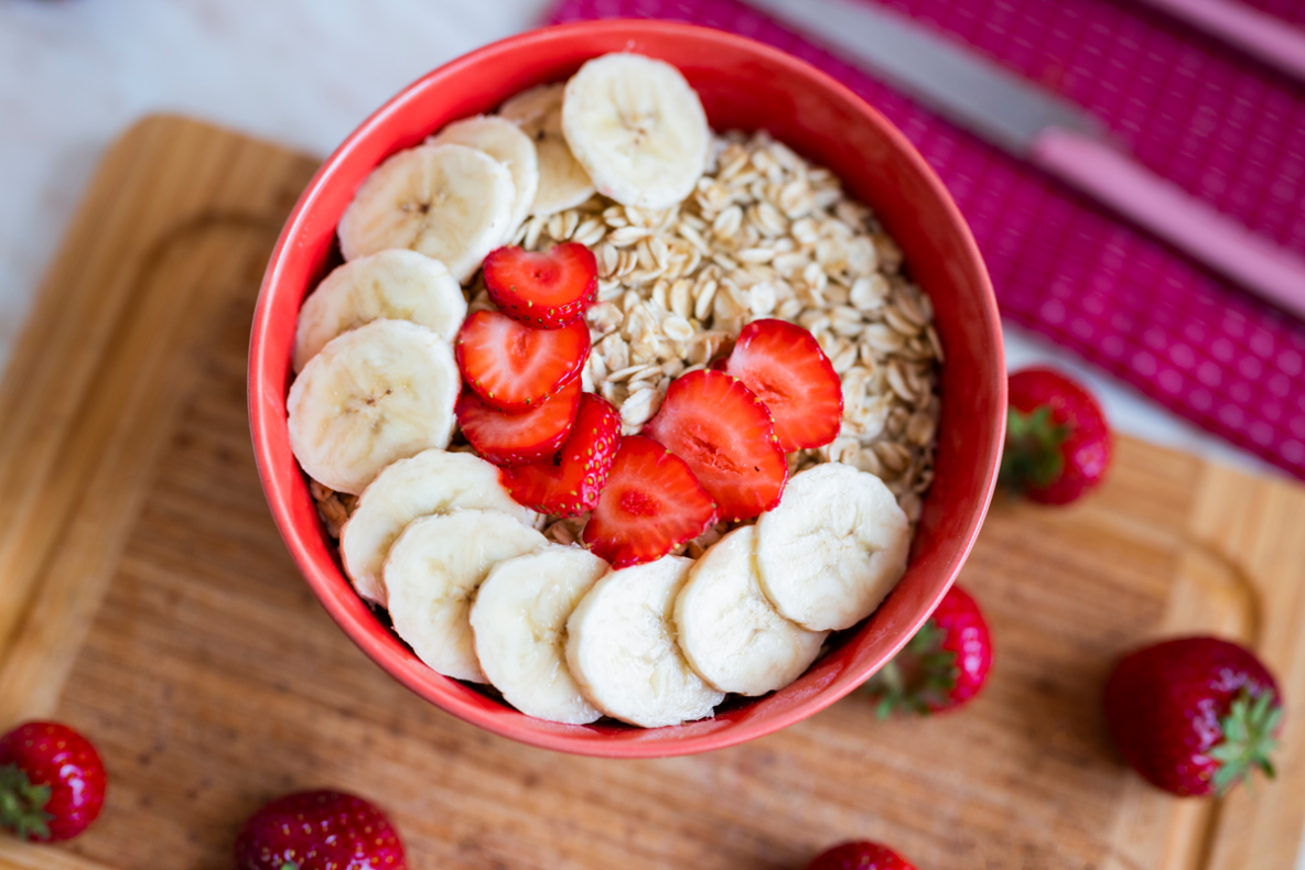 bowl of oatmeal with strawberries and bananas