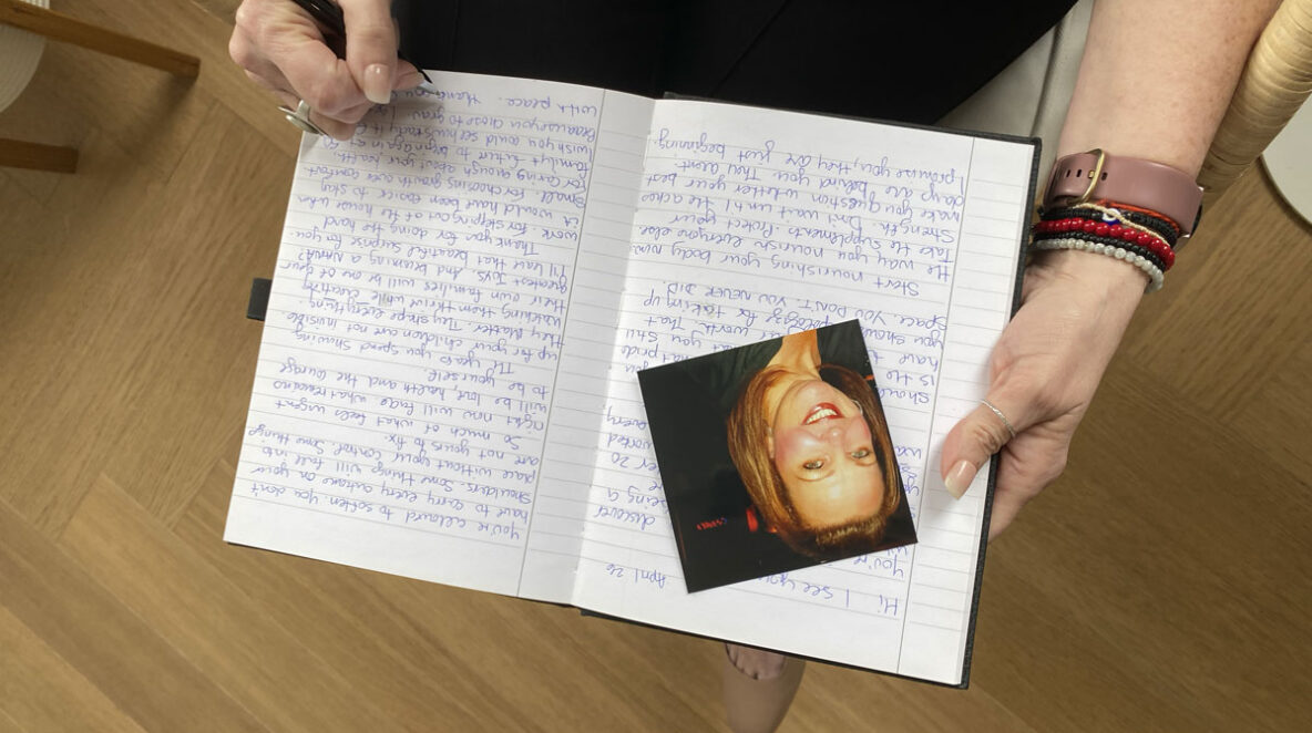 Fiona with a picture of her younger self and the letter she wrote to herself