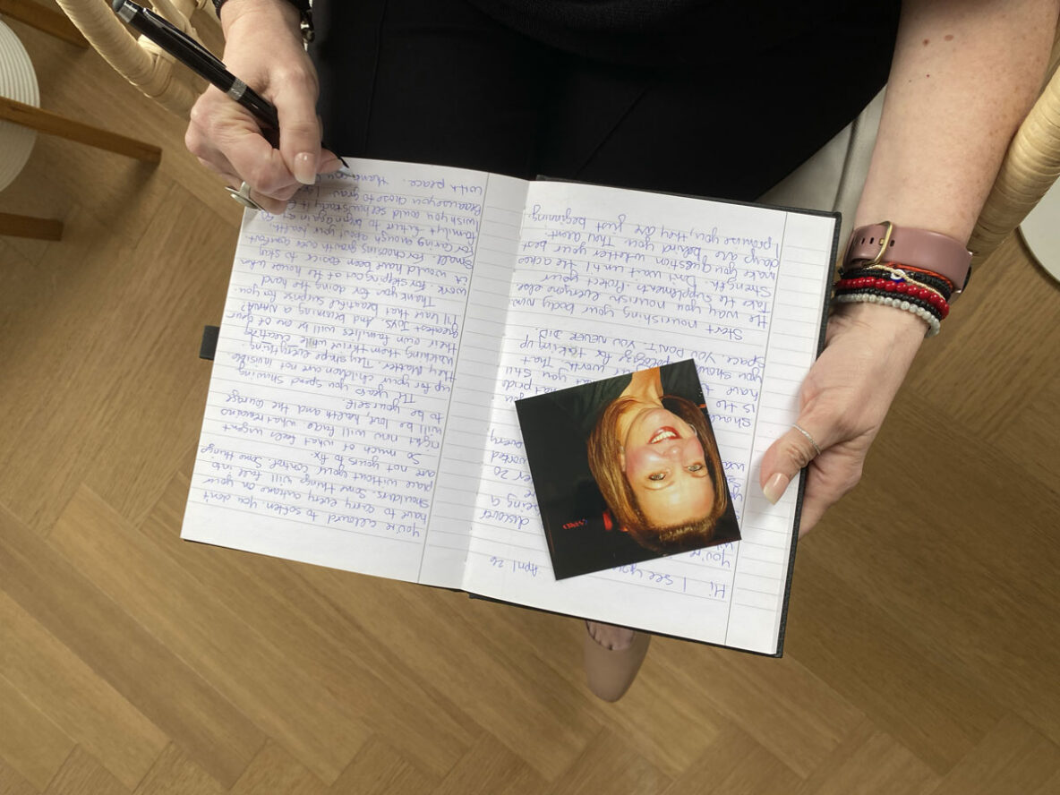 Fiona with a picture of her younger self and the letter she wrote to herself