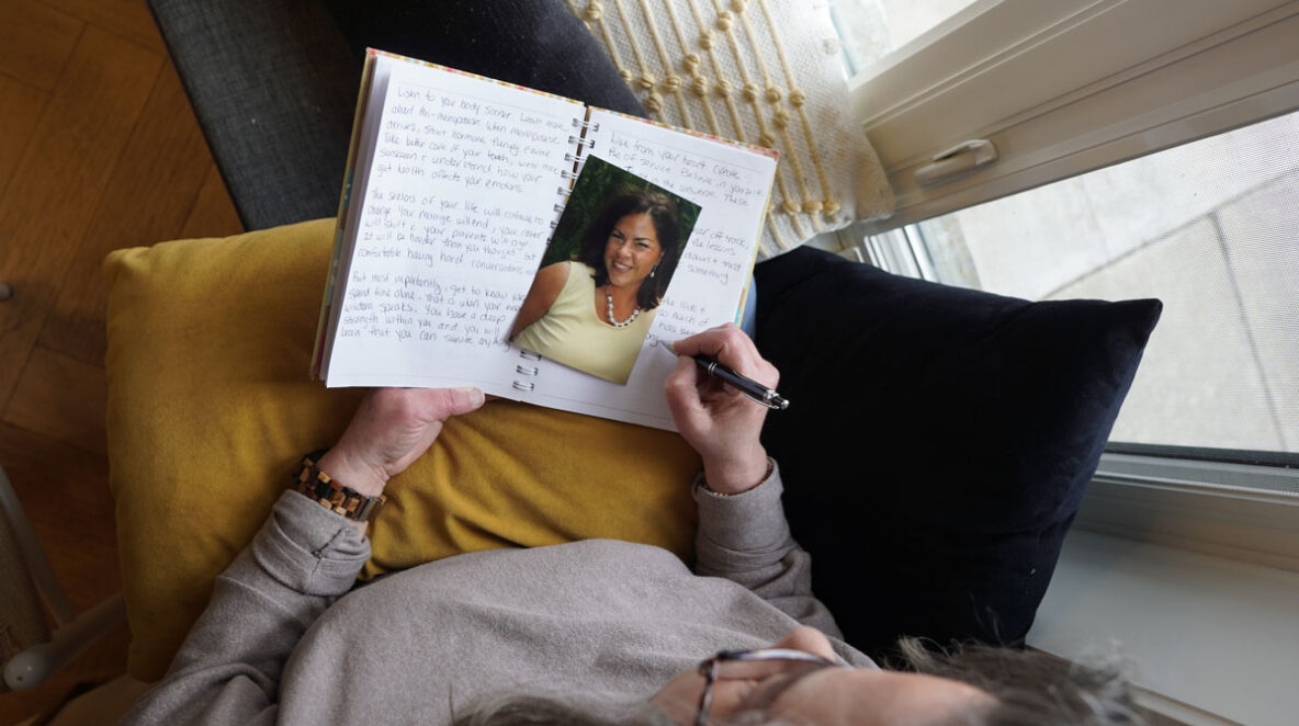 Lisa looking down at a picture of her younger self